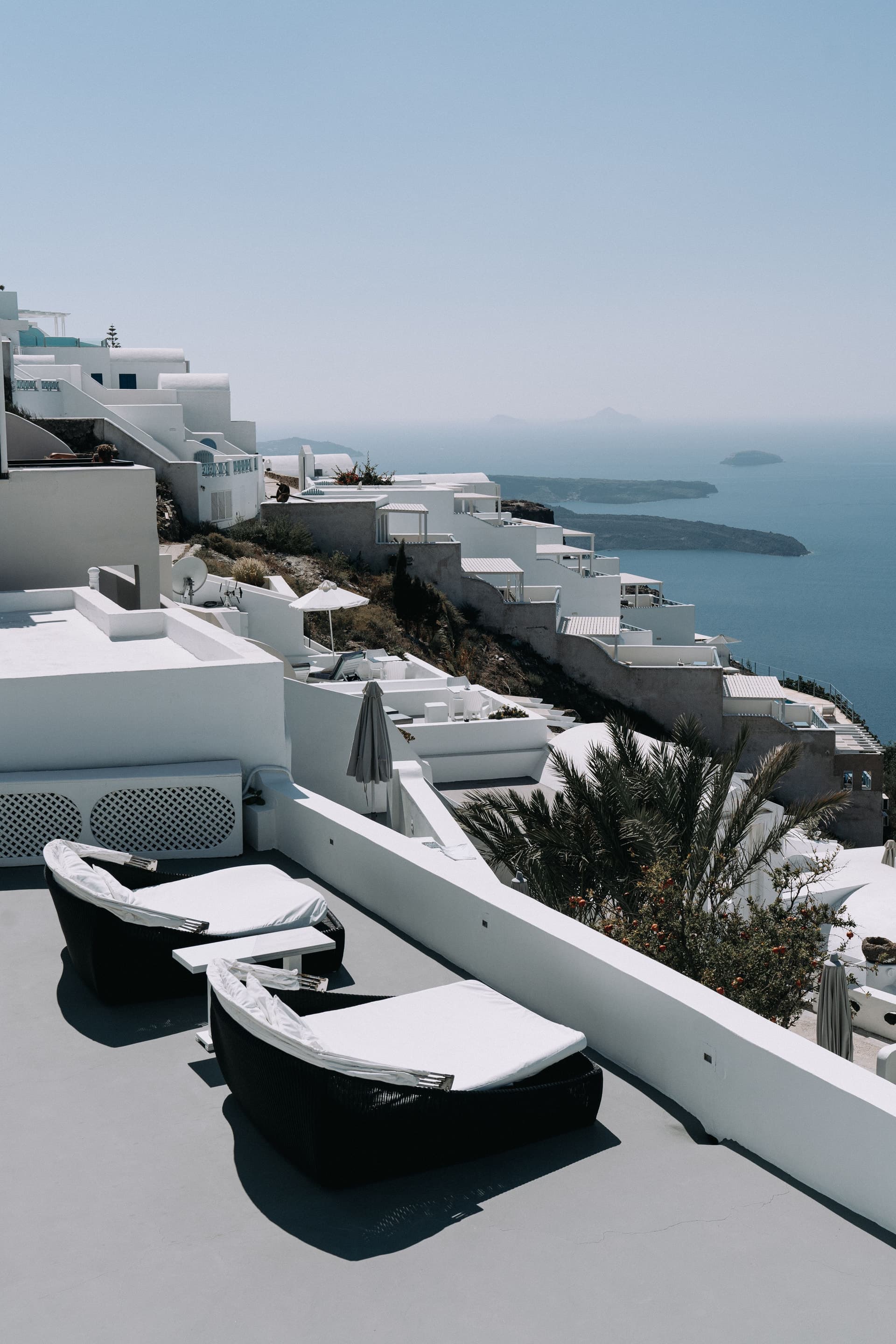 White hillside terraces and sun loungers overlooking the sea